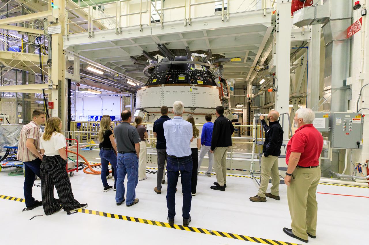 Artemis II crew members and their families view the Orion spacecraft for Artemis II during a tour of the Neil A. Armstrong Operations and Checkout Building at NASA’s Kennedy Space Center in Florida, on Friday, March 15, 2024. Artemis II Commander Reid Wiseman and Artemis II Mission Specialist Jeremy Hansen toured the facility with their families and viewed the Orion spacecraft for upcoming Artemis missions.