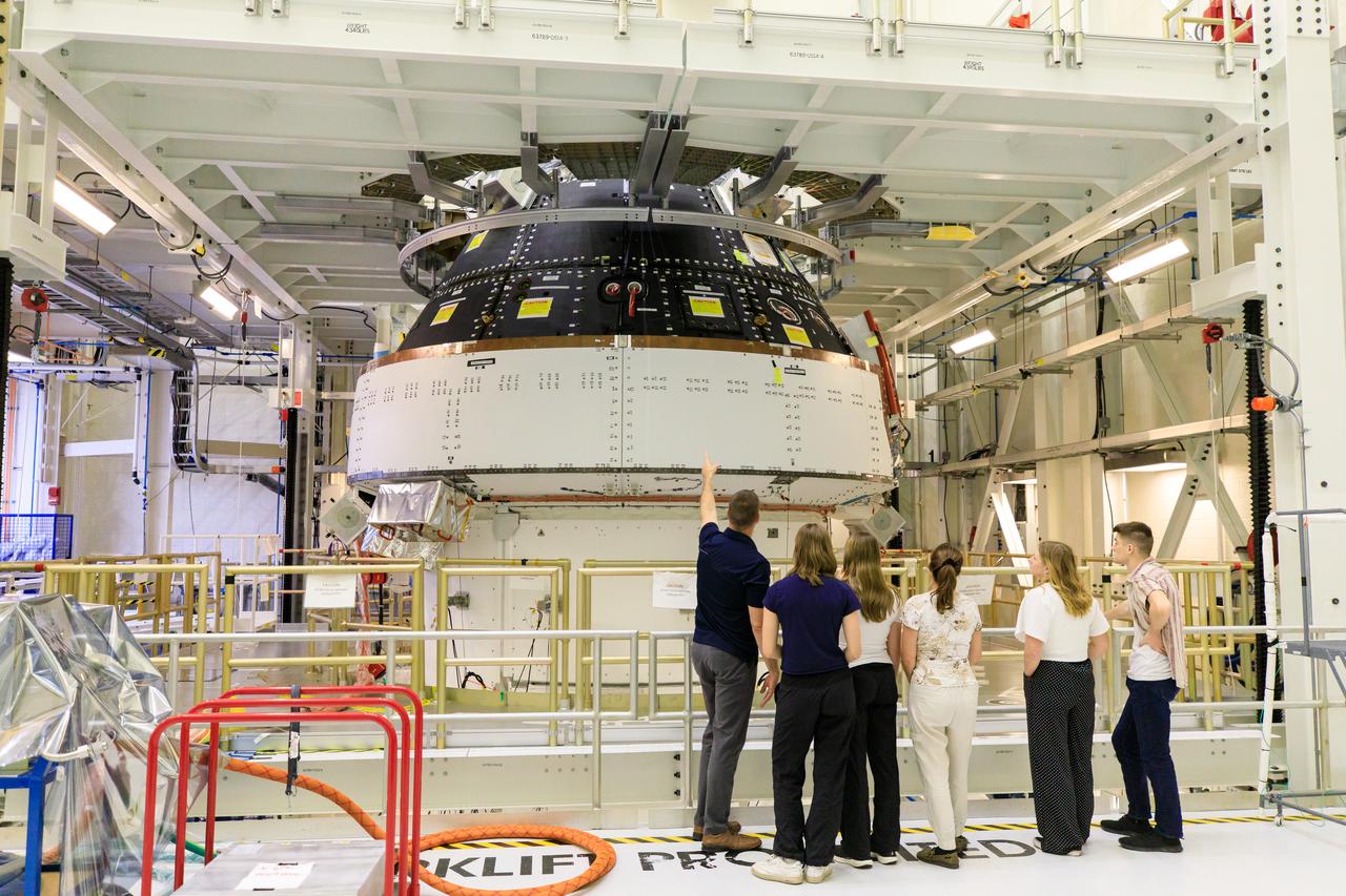 Artemis II Mission Specialist Jeremy Hansen and his family view the Orion spacecraft for Artemis II during a tour of the Neil A. Armstrong Operations and Checkout Building at NASA’s Kennedy Space Center in Florida, on Friday, March 15, 2024. Along with Artemis II Commander Reid Wiseman, Hansen toured the facility with family members and viewed the Orion crew modules, including the spacecraft that will take them, along with Artemis II Pilot Victor Glover and Artemis II Mission Specialist Christina Hammock Koch, around the Moon and back during the Artemis II mission.