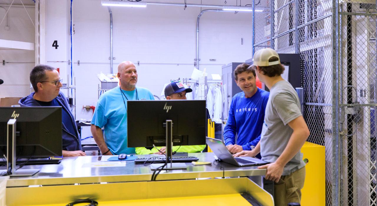 Artemis Commander Reid Wiseman visits with employees from ASRC inside the Neil A. Armstrong Operations and Checkout Building at NASA’s Kennedy Space Center in Florida, on Friday, March 15, 2024. The Artemis II crew members toured the facility with family members and viewed the Orion crew modules, including the spacecraft that will take them, along with Artemis II Pilot Victor Glover and Artemis II Mission Specialist Christina Hammock Koch, around the Moon and back during the Artemis II mission.