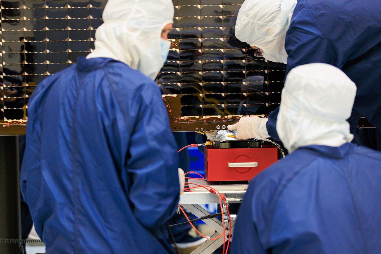 Technicians inside the Payload Hazardous Servicing Facility at NASA’s Kennedy Space Center in Florida install and test one of several antennas on a solar array Wednesday, March 20, 2024, for the agency’s Europa Clipper spacecraft which will study Jupiter’s icy moon Europa to determine if the planet has conditions that could support life. REASON, (Radar for Europa Assessment and Sounding: Ocean to Near-surface) instrument will use the antennas to send both High Frequency (HF) and Very High Frequency (VHF) radio waves to penetrate up to 18 miles (30 kilometers) deep and search the ocean, measure ice thickness, and study the topography, composition, and roughness of Europa’s surface. The Europa Clipper spacecraft will ship to Florida later this year from NASA’s Jet Propulsion Lab in Southern California in preparation for launch aboard a SpaceX Falcon Heavy rocket from Kennedy’s Launch Complex 39A targeting October 2024.