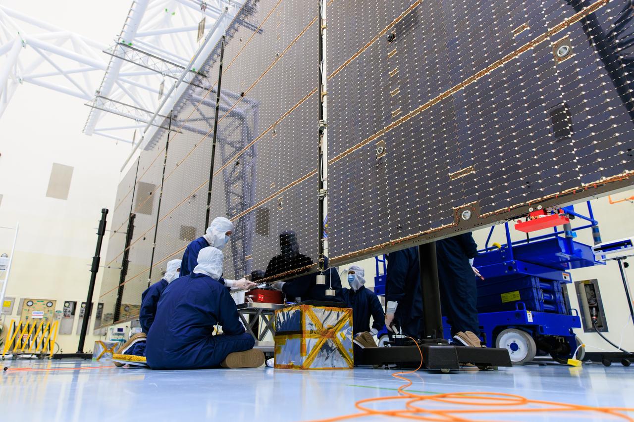 Technicians inside the Payload Hazardous Servicing Facility at NASA’s Kennedy Space Center in Florida install and test one of several antennas on a solar array Wednesday, March 20, 2024, for the agency’s Europa Clipper spacecraft which will study Jupiter’s icy moon Europa to determine if the planet has conditions that could support life. REASON, (Radar for Europa Assessment and Sounding: Ocean to Near-surface) instrument will use the antennas to send both High Frequency (HF) and Very High Frequency (VHF) radio waves to penetrate up to 18 miles (30 kilometers) deep and search the ocean, measure ice thickness, and study the topography, composition, and roughness of Europa’s surface. The Europa Clipper spacecraft will ship to Florida later this year from NASA’s Jet Propulsion Lab in Southern California in preparation for launch aboard a SpaceX Falcon Heavy rocket from Kennedy’s Launch Complex 39A targeting October 2024.