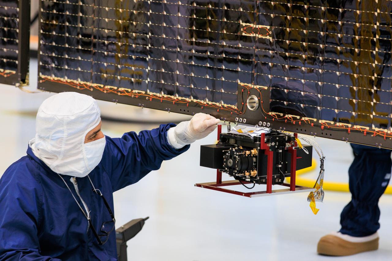 Technicians inside the Payload Hazardous Servicing Facility at NASA’s Kennedy Space Center in Florida install and test antennas on a solar array on Wednesday, March 20, 2024, for the agency’s Europa Clipper spacecraft which will study Jupiter’s icy moon Europa to determine if the planet has conditions that could support life. The REASON, (Radar for Europa Assessment and Sounding: Ocean to Near-surface) instrument will use the antennas to send both High Frequency (HF) and Very High Frequency (VHF) radio waves to penetrate up to 18 miles (30 kilometers) deep and search the ocean, measure ice thickness, and study the topography, composition, and roughness of Europa’s surface. The Europa Clipper spacecraft will ship to Florida later this year from NASA’s Jet Propulsion Lab in Southern California in preparation for launch aboard a SpaceX Falcon Heavy rocket from Kennedy’s Launch Complex 39A targeting October.