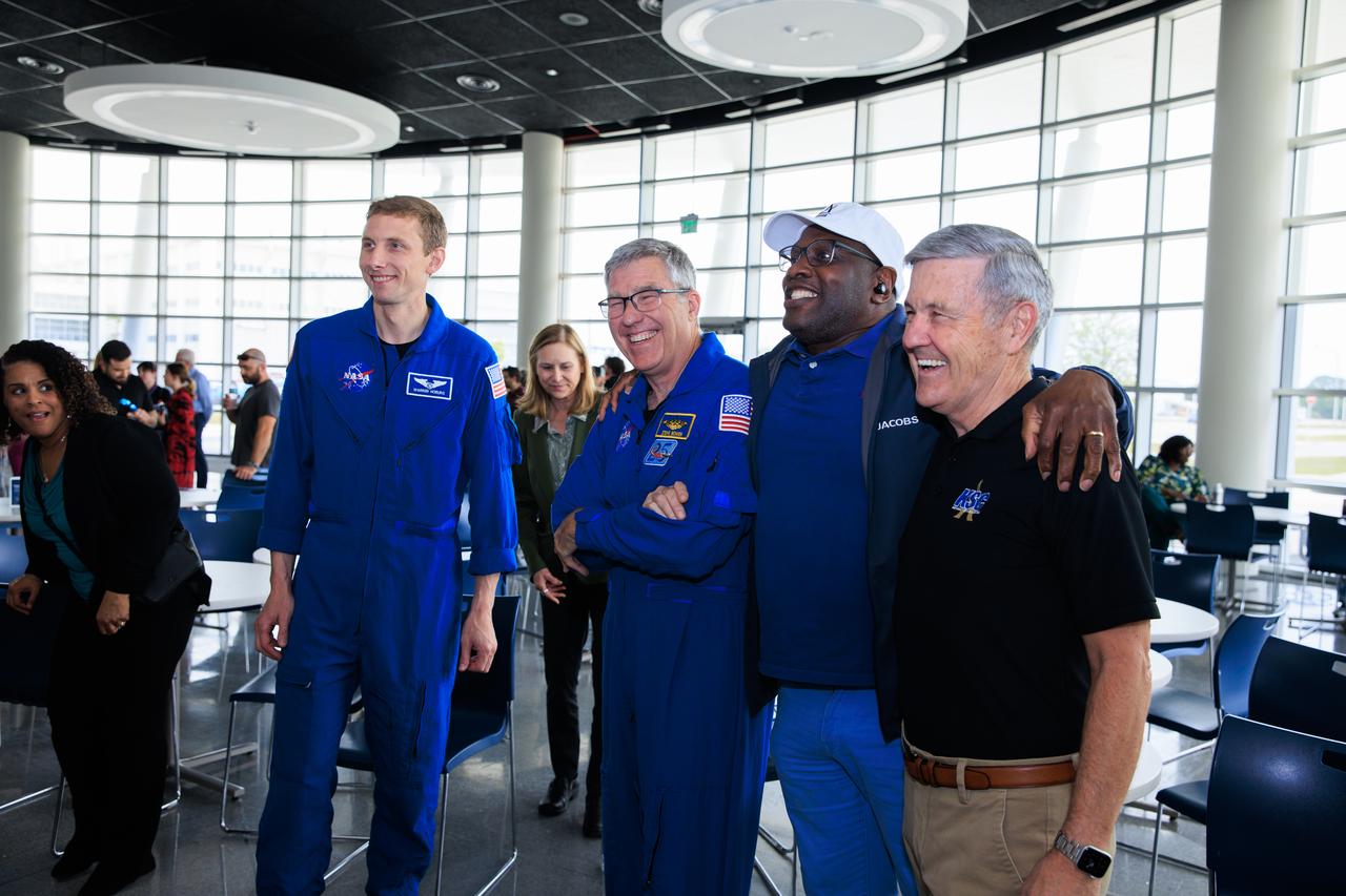 NASA’s SpaceX Crew-6 astronauts Warren “Woody” Hoburg and Stephen Bowen pose for a photo with a NASA employee and former Kennedy Space Center director Bob Cabana during a meet-and-greet at the agency’s Central Campus Headquarters cafeteria at Kennedy Space Center in Florida on Wednesday, March 27, 2024. The session was a chance for employees and other personnel to meet with the Crew-6 astronauts and celebrate the recent retirement of Bob Cabana who held the position for 13 years.