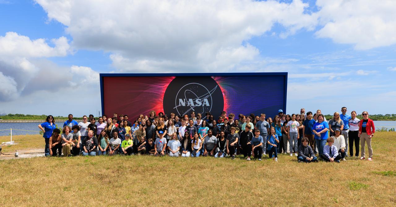 Students from Andrew Jackson Middle School in Titusville, Florida, pose for a photo in front of the iconic countdown clock at NASA’s Kennedy Space Center in Florida on Tuesday, April 2, 2024. As part of the agency’s NextGen STEM project, the students joined others from across the country who participated virtually for an environmentally focused Earth Day briefing held inside Kennedy’s news auditorium to discuss how technology and science coexist with nature at the spaceport. 