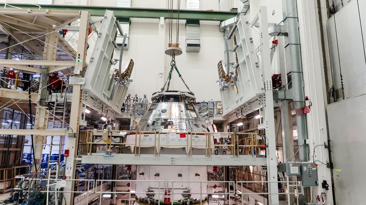 On April 4, 2024, a team lifts the Artemis II Orion spacecraft into a vacuum chamber inside the Operations and Checkout Building at NASA's Kennedy Space Center in Florida, where it will undergo electromagnetic compatibility and interference testing.