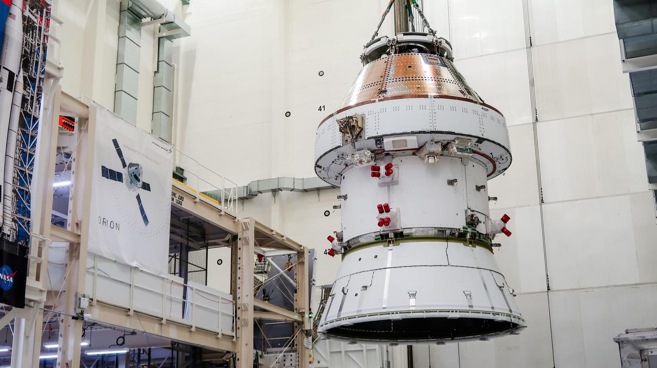 On April 4, 2024, a team lifts the Artemis II Orion spacecraft into a vacuum chamber inside the Operations and Checkout Building at NASA's Kennedy Space Center in Florida, where it will undergo electromagnetic compatibility and interference testing.