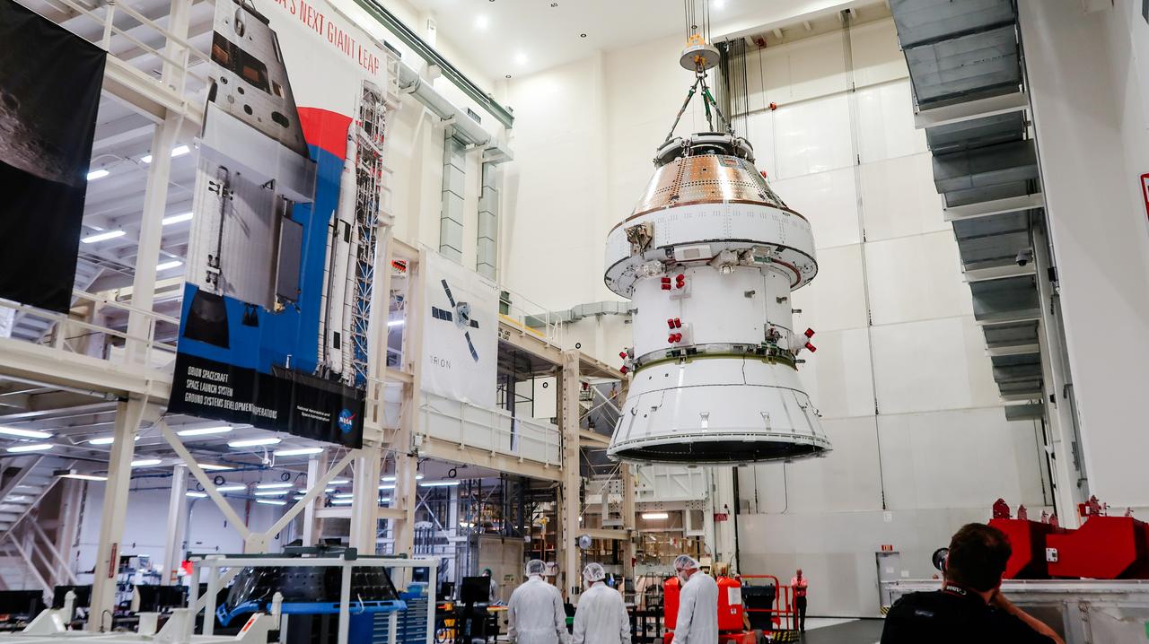 On April 4, 2024, a team lifts the Artemis II Orion spacecraft into a vacuum chamber inside the Operations and Checkout Building at NASA's Kennedy Space Center in Florida, where it will undergo electromagnetic compatibility and interference testing.