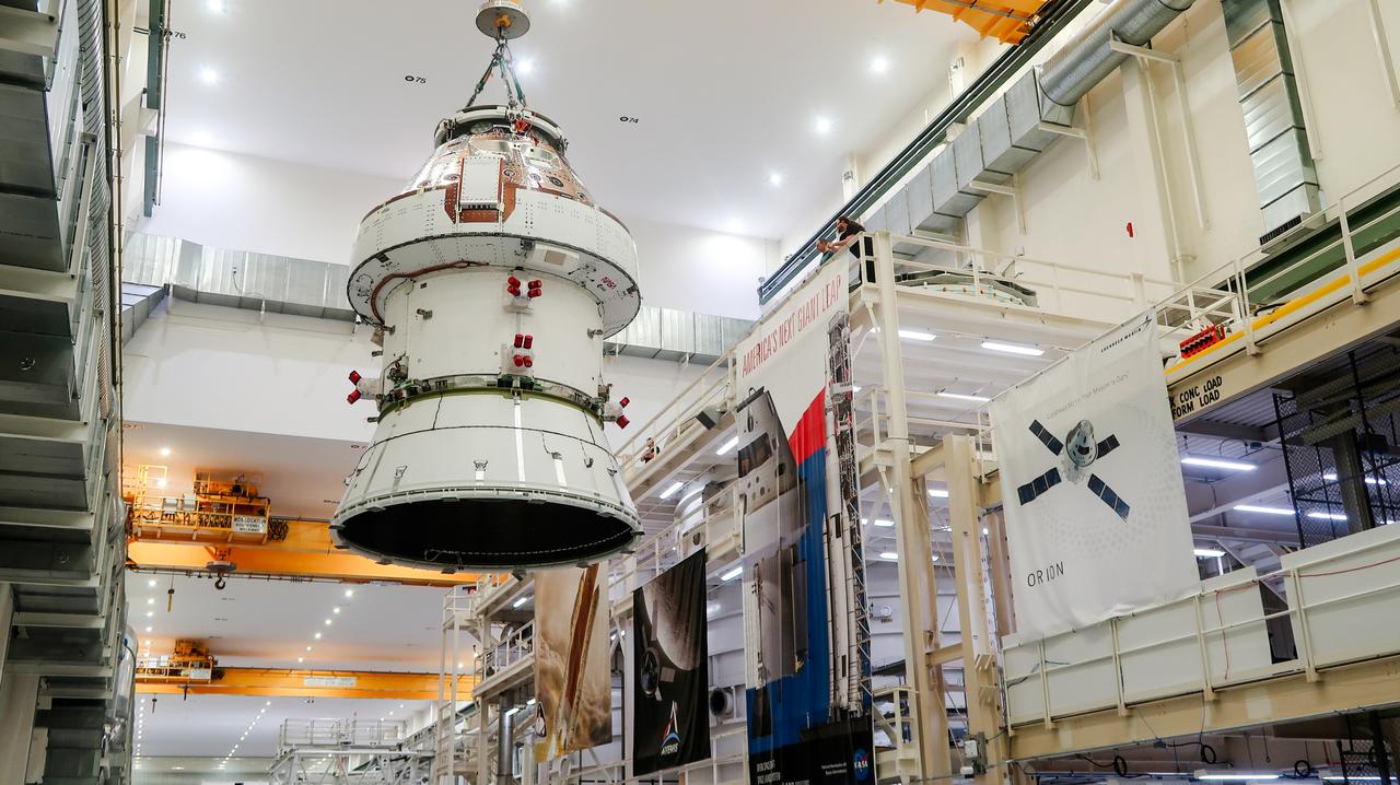 On April 4, 2024, a team lifts the Artemis II Orion spacecraft into a vacuum chamber inside the Operations and Checkout Building at NASA's Kennedy Space Center in Florida, where it will undergo electromagnetic compatibility and interference testing.
