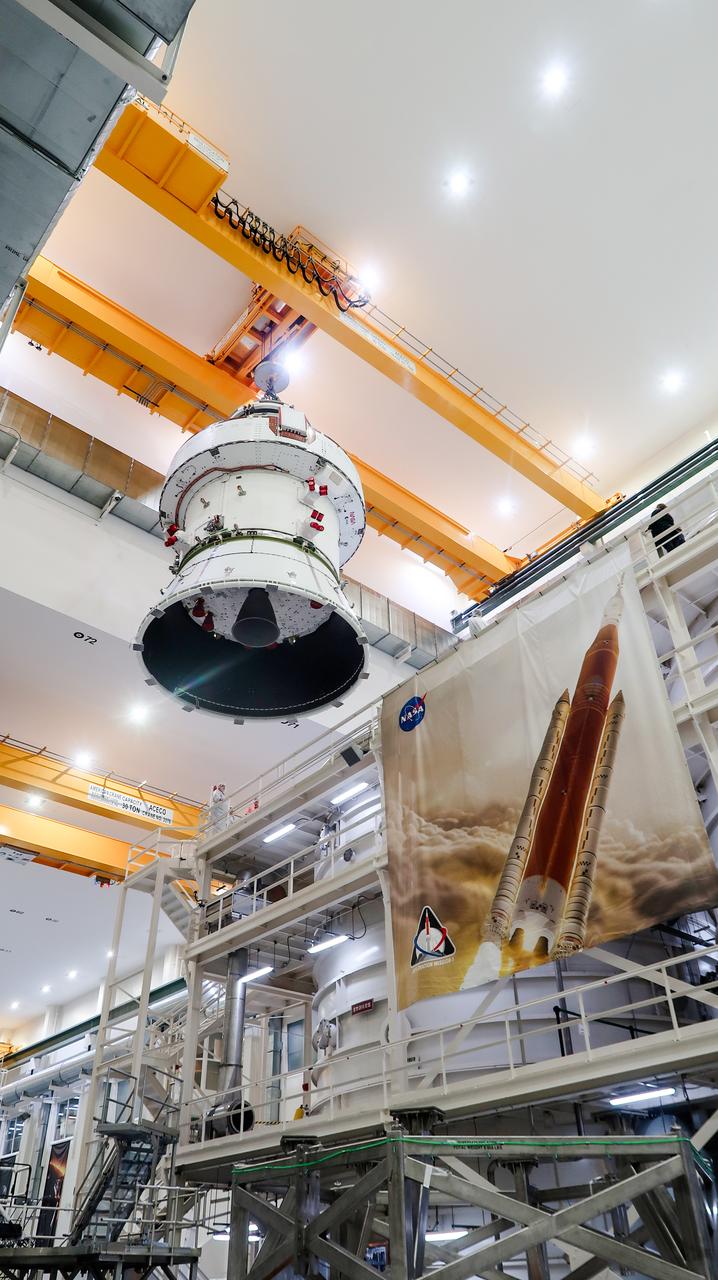 On April 4, 2024, a team lifts the Artemis II Orion spacecraft into a vacuum chamber inside the Operations and Checkout Building at NASA's Kennedy Space Center in Florida, where it will undergo electromagnetic compatibility and interference testing.