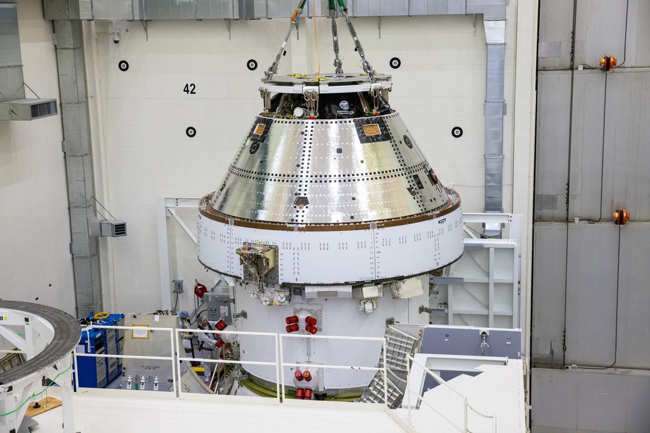 On April 4, 2024, teams lift the Artemis II Orion spacecraft into a vacuum chamber inside the Operations and Checkout Building at NASA's Kennedy Space Center in Florida, where it will undergo electromagnetic compatibility and interference testing. 