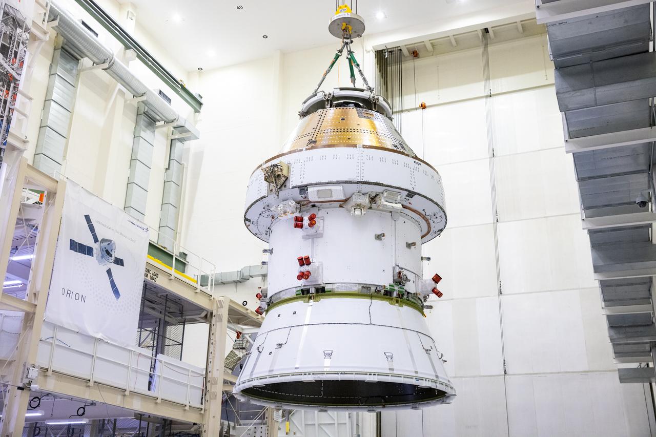 On April 4, 2024, teams lift the Artemis II Orion spacecraft into a vacuum chamber inside the Operations and Checkout Building at NASA's Kennedy Space Center in Florida, where it will undergo electromagnetic compatibility and interference testing. 