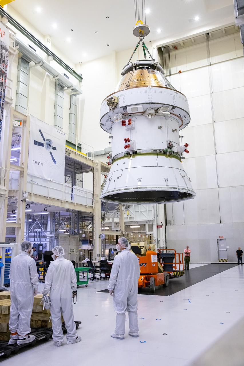 On April 4, 2024, technicians monitor as teams lift the Artemis II Orion spacecraft into a vacuum chamber inside the Operations and Checkout Building at NASA's Kennedy Space Center in Florida, where it will undergo electromagnetic compatibility and interference testing. 