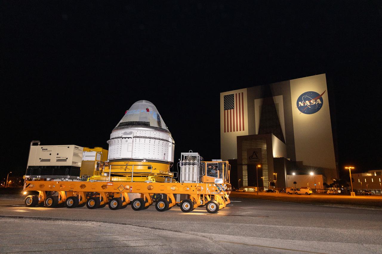 Boeing’s Starliner spacecraft, set to carry NASA astronauts Butch Wilmore and Suni Williams on the agency’s Boeing Crew Flight Test to the International Space Station, passes in front of the iconic Vehicle Assembly Building at NASA’s Kennedy Space Center in Florida on Tuesday, April 16, 2024. The spacecraft began its journey from the company’s Commercial Crew and Cargo Processing Facility and will be transported to ULA’s (United Launch Alliance) Vertical Integration Facility at Space Launch Complex-41 at Cape Canaveral Space Force Station prior to being lifted and connected to the Atlas V rocket, which is slated to launch no earlier than Monday, May 6, 2024.