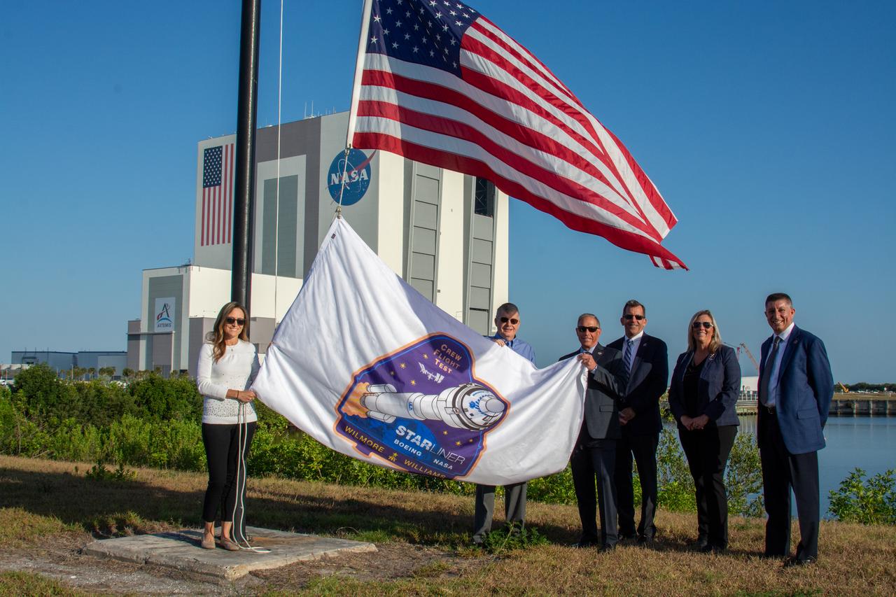 From left to right, Courtney Stern, ground and mission operations recovery/rescue, NASA Kennedy Space Center Commercial Crew Program; Steve Stich, manager, NASA’s Commercial Crew Program; Mark Nappi, vice president and manager, Boeing Commercial Crew Program; Leroy Cain, mission integration and operations manager, Boeing’s Commercial Crew Program; Dana Hutcherson, deputy manager, NASA’s Commercial Crew Program; and Richard Jones, deputy manager, NASA’s Commercial Crew Program, prepare to raise the NASA’s Boeing Crew Flight Test flag on Thursday, April 25, 2024, near the countdown clock at the Press Site at the Florida spaceport. As part of the agency’s Commercial Crew Program, NASA astronauts Butch Wilmore and Suni Williams are the first to launch to the International Space Station aboard Boeing’s Starliner spacecraft atop a United Launch Alliance Atlas V rocket from nearby Space Launch Complex-41 at Cape Canaveral Space Force Station. Liftoff is scheduled for 10:34 p.m. ET on Monday, May 6.