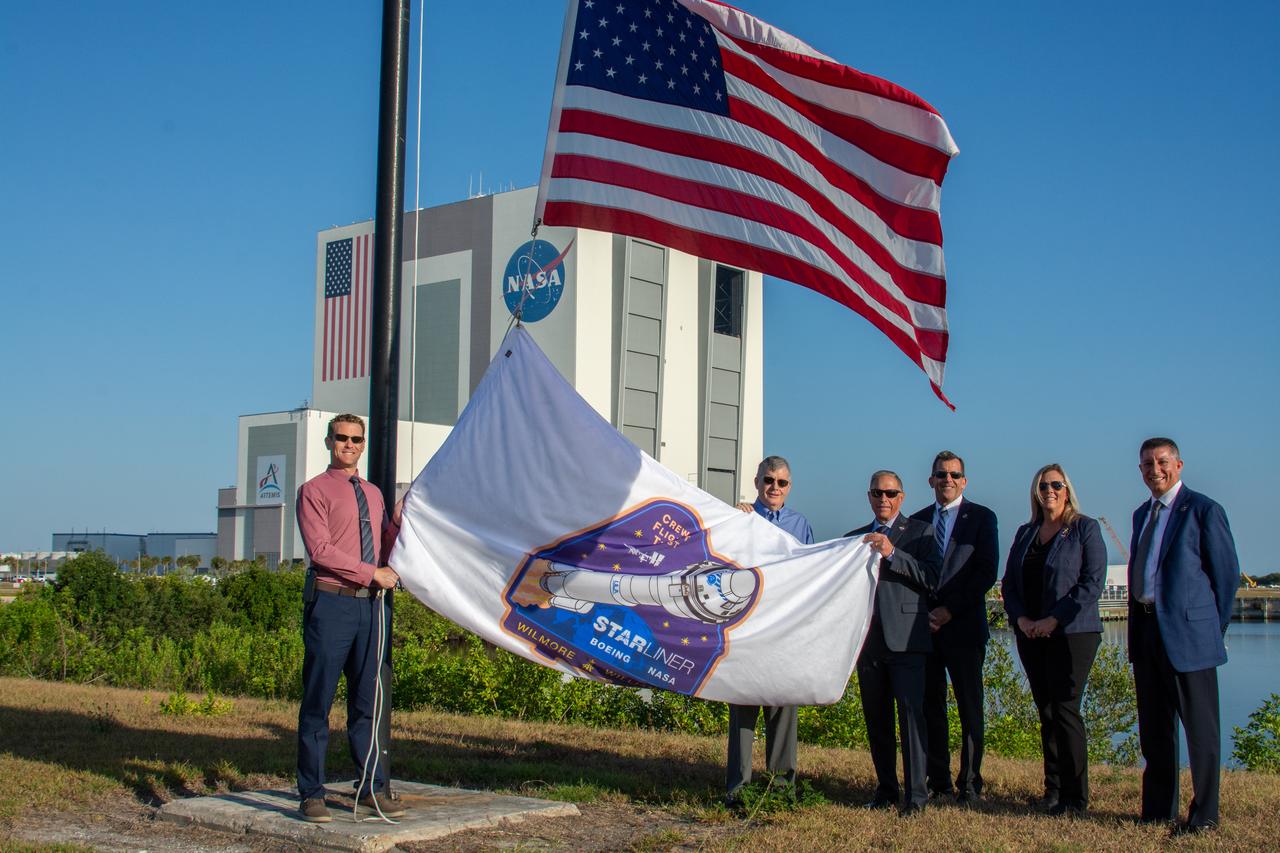 From left to right, Ian Kappes, deputy launch vehicle office manager, NASA Kennedy Space Center Commercial Crew Program; Steve Stich, manager, NASA’s Commercial Crew Program; Mark Nappi, vice president and program manager, Boeing Commercial Crew Program; Leroy Cain, mission integration and operations manager, Boeing’s Commercial Crew Program; Dana Hutcherson, deputy program manager, NASA’s Commercial Crew Program; and Richard Jones, deputy program manager, NASA’s Commercial Crew Program, prepare to raise NASA’s Boeing Crew Flight Test flag on Thursday, April 25, 2024, near the countdown clock at the Press Site at the Florida spaceport. As part of the agency’s Commercial Crew Program, NASA astronauts Butch Wilmore and Suni Williams are the first to launch to the International Space Station aboard Boeing’s Starliner spacecraft atop a United Launch Alliance Atlas V rocket from Space Launch Complex-41 at nearby Cape Canaveral Space Force Station. Liftoff is scheduled for 10:34 p.m. ET on Monday, May 6.