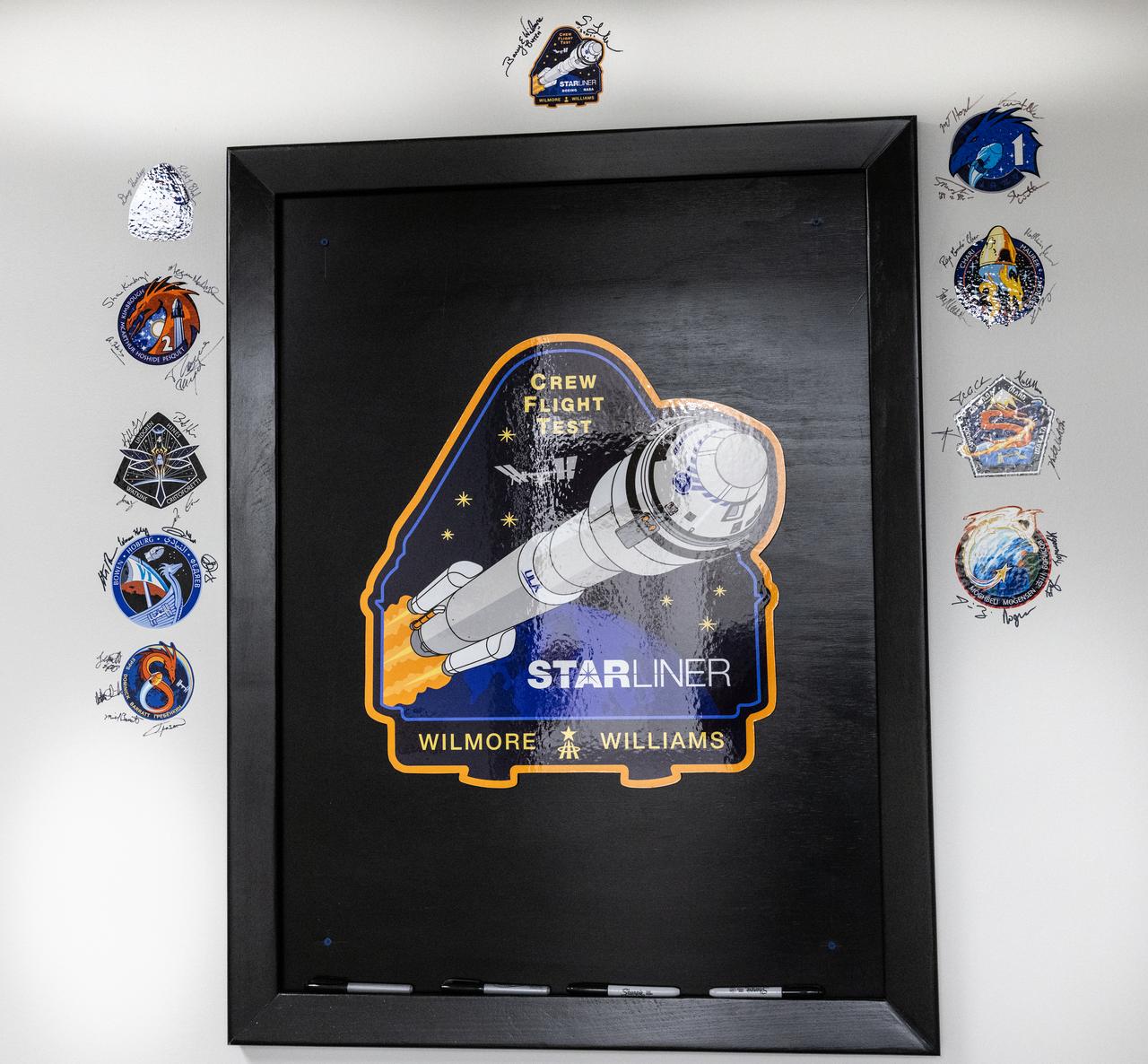 The signatures of NASA astronauts Butch Wilmore and Suni Williams are photographed alongside NASA’s Boeing Crew Flight Test mission insignia inside the Astronaut Crew Quarters in the Neil A. Armstrong Operations and Checkout Building at NASA’s Kennedy Space Center in Florida on Friday, April 26, 2024. Wilmore and Williams are the first to launch aboard Boeing’s Starliner spacecraft atop a United Launch Alliance Atlas V rocket from Space Launch Complex-41 at nearby Cape Canaveral Space Force Station. Liftoff is scheduled for 10:34 p.m. ET on Monday, May 6.