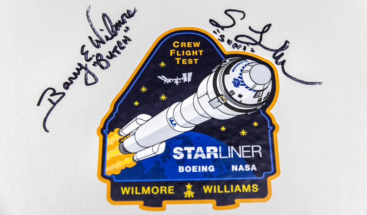 The signatures of NASA astronauts Butch Wilmore and Suni Williams are photographed alongside NASA’s Boeing Crew Flight Test mission insignia inside the Astronaut Crew Quarters in the Neil A. Armstrong Operations and Checkout Building at NASA’s Kennedy Space Center in Florida on Friday, April 26, 2024. Wilmore and Williams are the first to launch aboard Boeing’s Starliner spacecraft atop a United Launch Alliance Atlas V rocket from Space Launch Complex-41 at nearby Cape Canaveral Space Force Station. Liftoff is scheduled for 10:34 p.m. ET on Monday, May 6.