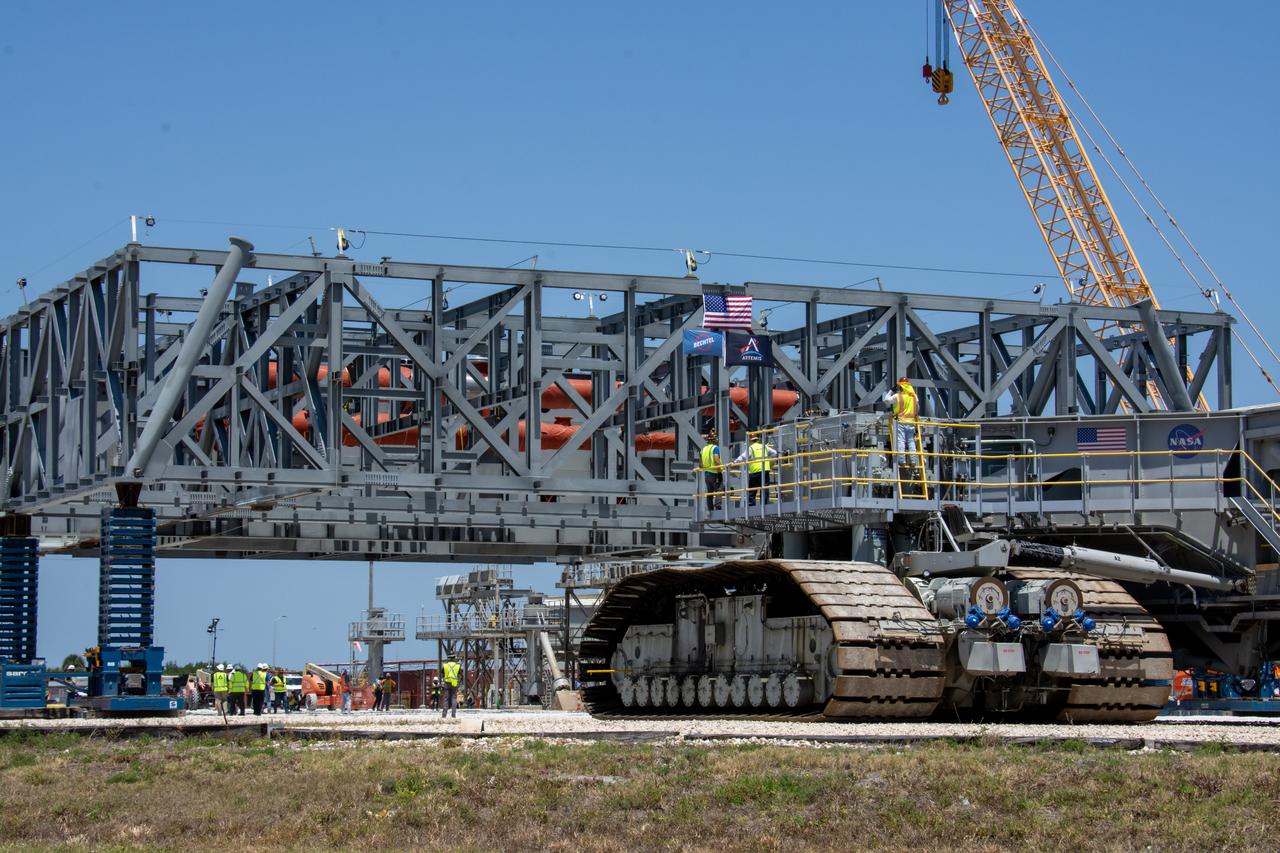 On Thursday, May 9, 2024, teams with NASA’s Exploration Ground Systems Program and primary contractor, Bechtel National, Inc., continue moving the base structure of mobile launcher 2 to a permanent mount structure where assembly will be completed at Kennedy Space Center in Florida. The 355-foot-tall mobile launcher 2 with a two-story base and a tower will be used to assemble and process the SLS (Space Launch System) rocket and Orion spacecraft in the Vehicle Assembly Building on NASA’s upcoming Artemis missions to the Moon beginning with Artemis IV.