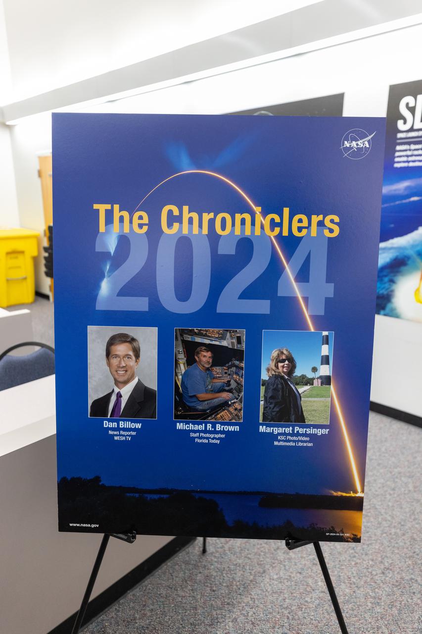 Dan Billow, Mike Brown, and Maggie Persinger were honored May 15, 2024, during the 2024 Kennedy Chroniclers ceremony at the Press Site at NASA’s Kennedy Space Center in Florida. Three brass plates bearing their names were added to the wall of the “bull pen,” where reporters traditionally gather to cover launches and events at NASA Kennedy. The three were honored for their efforts in helping tell the story of America’s space program, primarily from the Florida spaceport. They were nominated by their peers and selected by a panel of NASA officials and current space reporters.