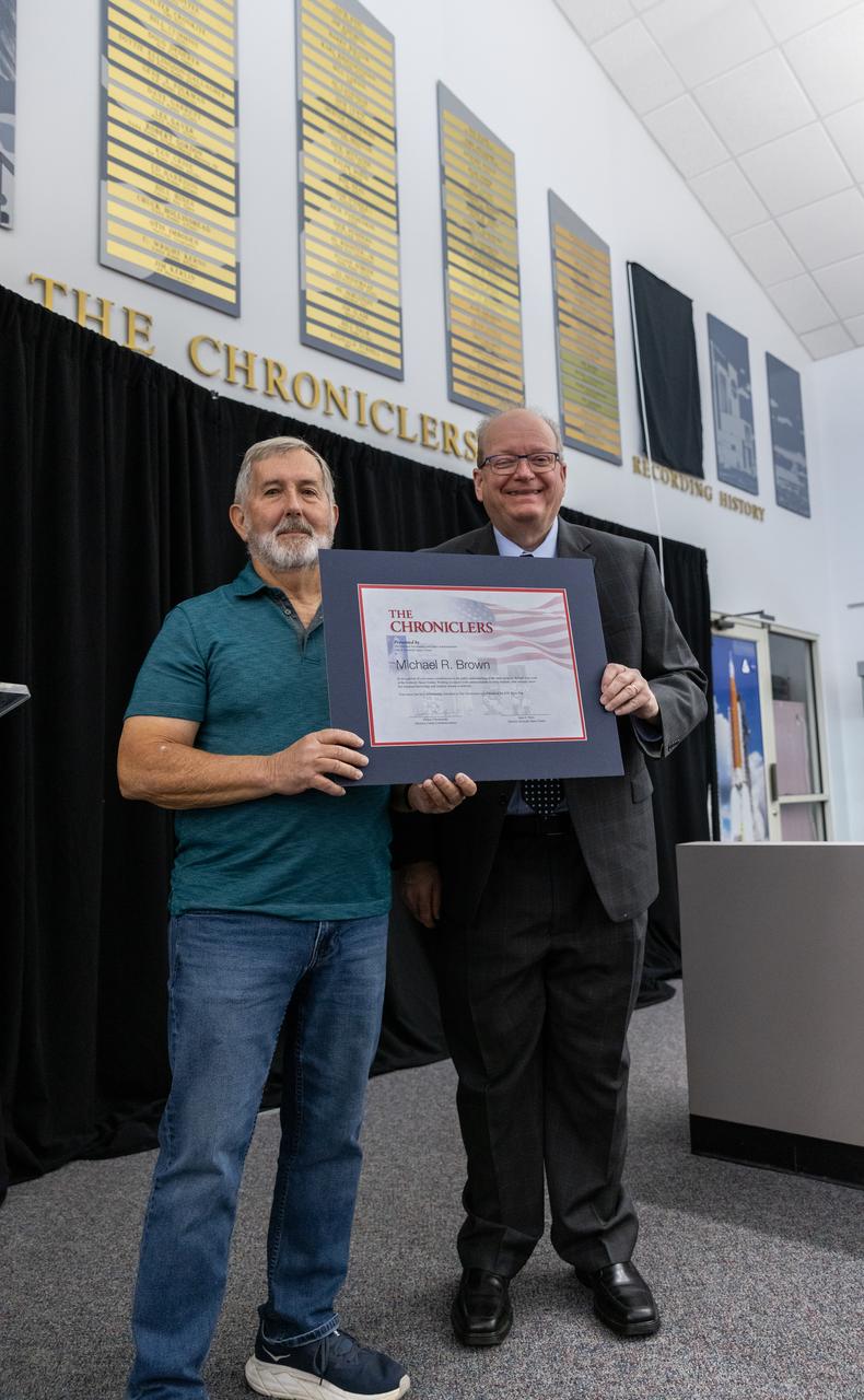 Mike Brown accepts a certificate naming him a Kennedy Chronicler during a May 15 ceremony at the Press Site at NASA’s Kennedy Space Center in Florida. Presenting the award is Burt Summerfield, NASA Kennedy Space Center’s associate director, management. Brown, a long-time space photographer, was among three reporters and industry professionals who were nominated by their peers and selected by a panel of NASA officials and current space reporters for their efforts in helping tell the story of America’s space program. Brass plates bearing their names were added to the wall of the “bull pen,” where reporters traditionally gather to cover launches and events at NASA Kennedy.
