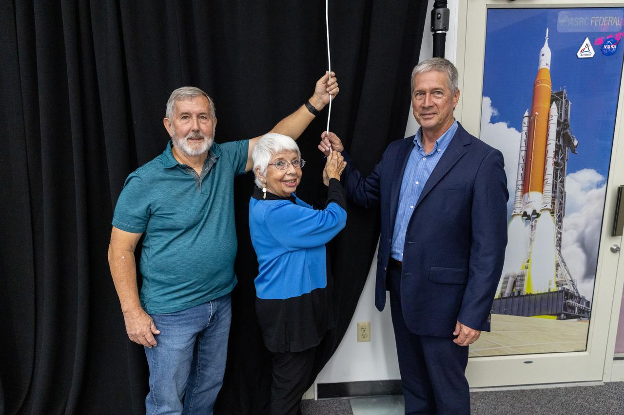 Mike Brown, Maggie Persinger, and Dan Billow were honored May 15, 2024, during the 2024 Kennedy Chroniclers ceremony at the Press Site at NASA’s Kennedy Space Center in Florida. Three brass plates bearing their names were added to the wall of the “bull pen,” where reporters traditionally gather to cover launches and events at NASA Kennedy. The three were honored for their efforts in helping tell the story of America’s space program, primarily from the Florida spaceport. They were nominated by their peers and selected by a panel of NASA officials and current space reporters.