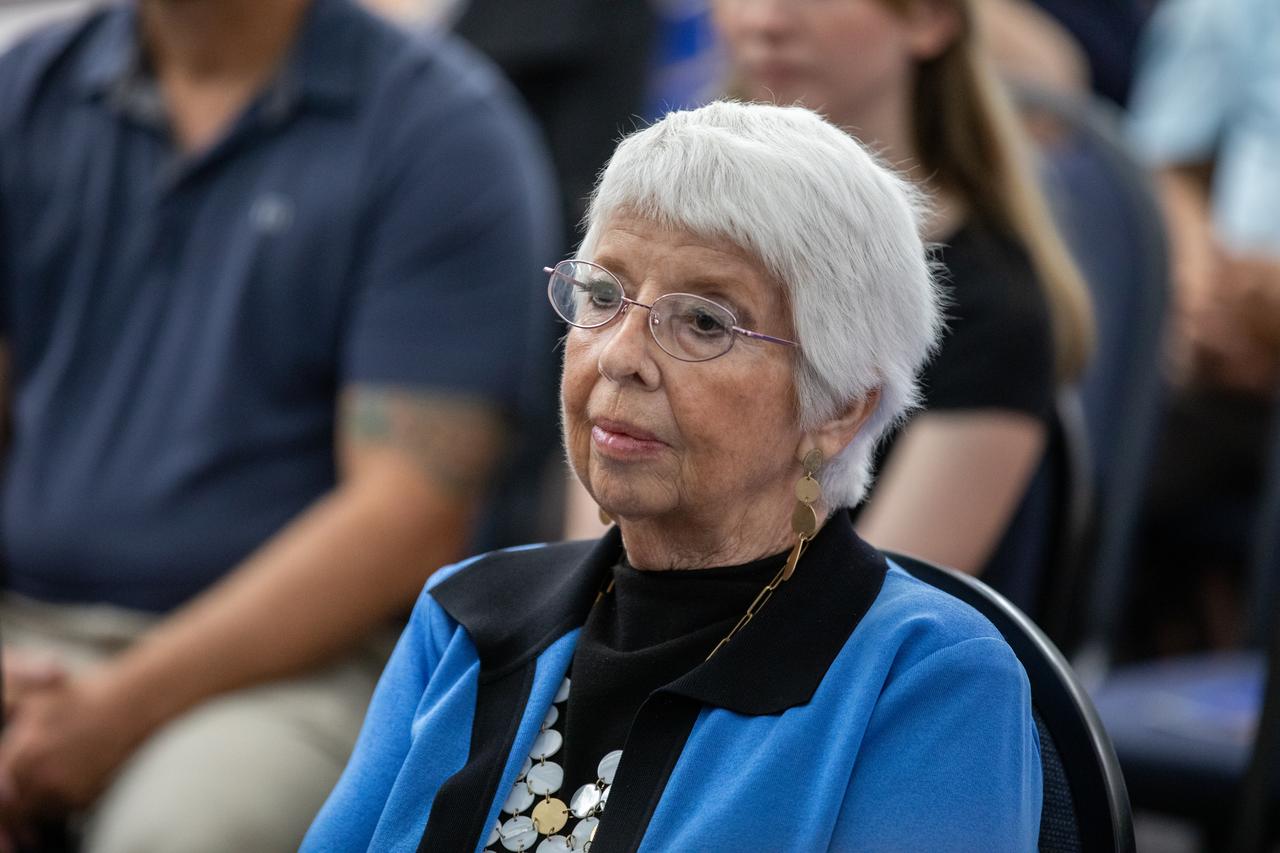 Maggie Persinger accepts a certificate naming her a Kennedy Chronicler during a May 15 ceremony at the Press Site at NASA’s Kennedy Space Center in Florida. Persinger, a retired NASA media librarian, was among three reporters and industry professionals who were nominated by their peers and selected by a panel of NASA officials and current space reporters for their efforts in helping tell the story of America’s space program. Brass plates bearing their names were added to the wall of the “bull pen,” where reporters traditionally gather to cover launches and events at NASA Kennedy.