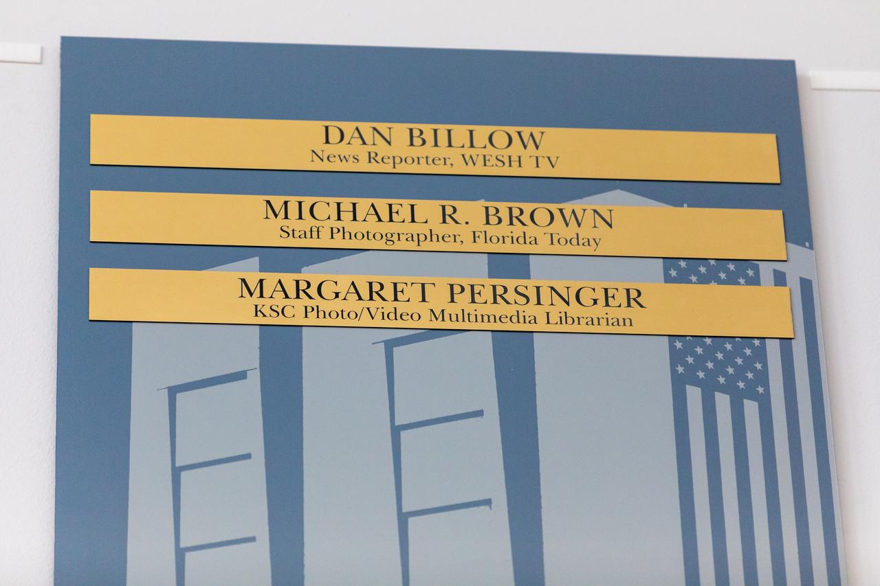 Dan Billow, Mike Brown, and Maggie Persinger were honored May 15, 2024, during the 2024 Kennedy Chroniclers ceremony at the Press Site at NASA’s Kennedy Space Center in Florida. Three brass plates bearing their names were added to the wall of the “bull pen,” where reporters traditionally gather to cover launches and events at NASA Kennedy. The three were honored for their efforts in helping tell the story of America’s space program, primarily from the Florida spaceport. They were nominated by their peers and selected by a panel of NASA officials and current space reporters.