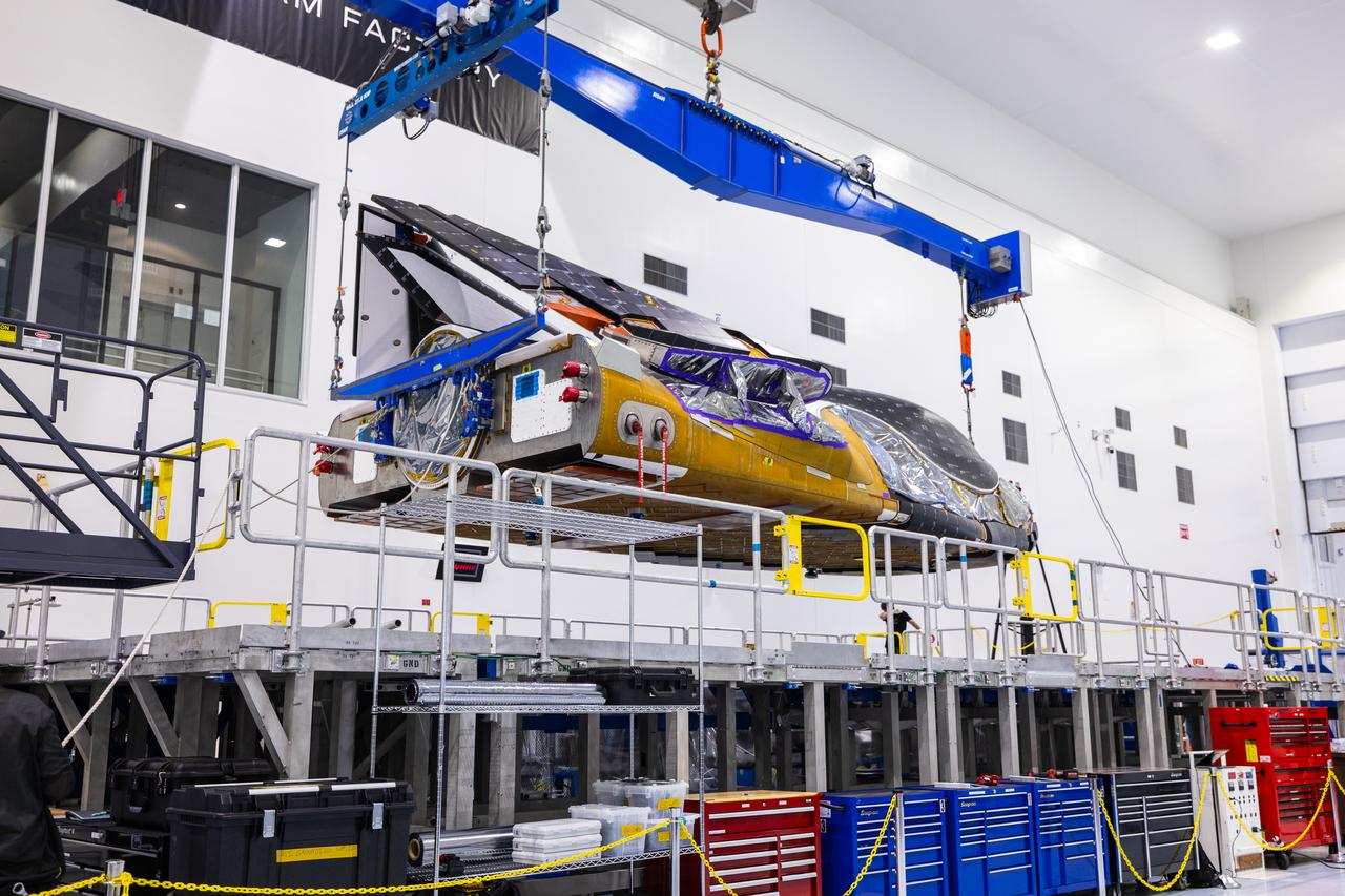Dream Chaser Tenacity, Sierra Space's uncrewed cargo spaceplane is lifted and moved by crane inside the Space Systems Processing Facility (SSPF) at NASA’s Kennedy Space Center in Florida on Monday, May 20, 2024. Dream Chaser Tenacity will undergo final testing and prelaunch processing inside the high bay of the SSPF ahead of its inaugural launch atop a ULA (United Launch Alliance) Vulcan rocket from nearby Cape Canaveral Space Force Station. The reusable transportation system is contracted to perform a minimum of seven cargo missions to the International Space Station as part of the agency’s efforts to expand commercial resupply services to low Earth orbit.