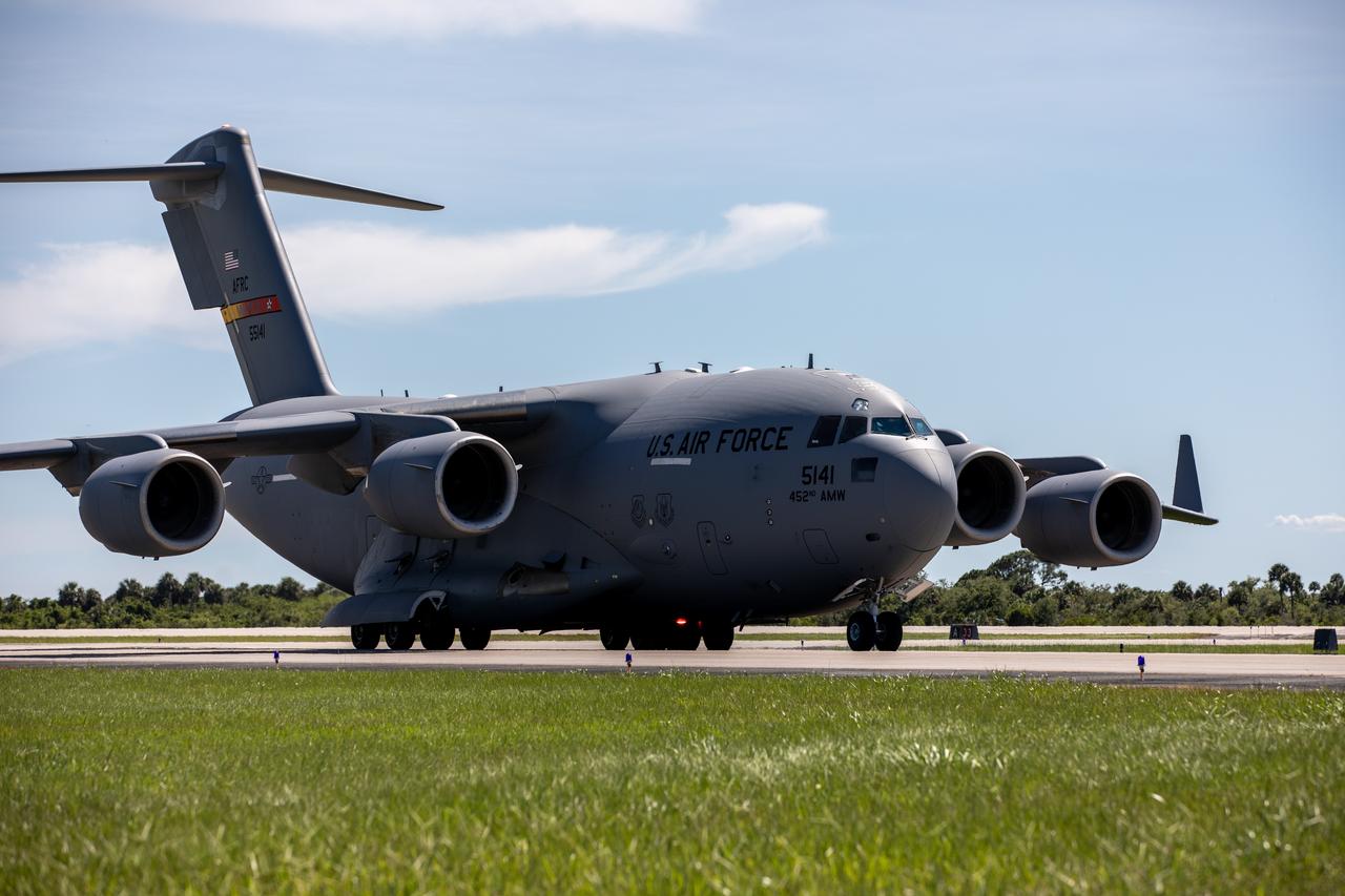 A United States Air Force C-17 Globemaster III transport aircraft carrying NASA’s largest planetary mission spacecraft, Europa Clipper, arrives at the Launch and Landing Facility at the agency's Kennedy Space Center in Florida on Thursday, May 23, 2024. Teams spent several hours offloading Europa Clipper then transferring it to the Payload Hazardous Servicing Facility at Kennedy to prepare it for launch aboard a SpaceX Falcon Heavy rocket later this year from Launch Complex 39A at the Florida spaceport. Europa Clipper will help determine if life-sustaining conditions exist below the surface Jupiter’s fourth largest moon, Europa.