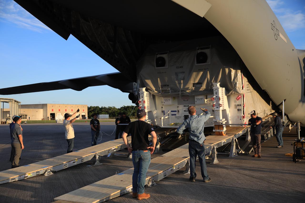 Technicians offload NASA’s largest planetary mission spacecraft, Europa Clipper, from a United States Air Force C-17 Globemaster III transport aircraft at the Launch and Landing Facility at NASA’s Kennedy Space Center in Florida on Thursday, May 23, 2024. Crews will prepare it for launch aboard a SpaceX Falcon Heavy rocket from Launch Complex 39A at the Florida spaceport, targeting liftoff in October. Europa Clipper will help determine if life-sustaining conditions exist below the surface of Jupiter’s fourth largest moon, Europa.