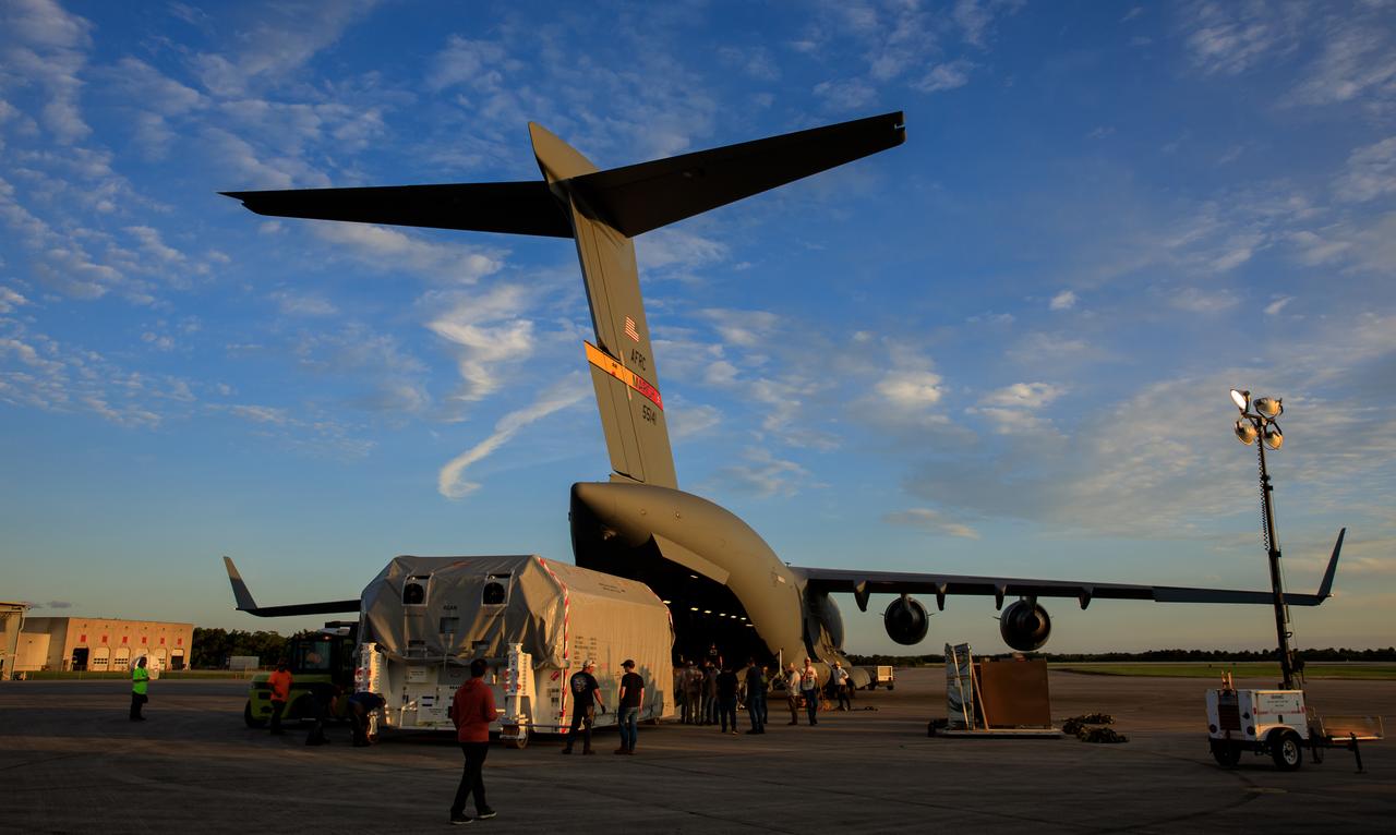 Teams offload NASA’s largest planetary mission spacecraft, Europa Clipper, from a United States Air Force C-17 Globemaster III transport aircraft onto the flatbed of a heavy-lift truck at the Launch and Landing Facility at NASA’s Kennedy Space Center in Florida on Thursday, May 23, 2024. Crews transported Europa Clipper to the Payload Hazardous Servicing Facility at Kennedy to prepare it for launch aboard a SpaceX Falcon Heavy rocket later this year from Launch Complex 39A at the Florida spaceport. Europa Clipper will help determine if conditions exist below the surface Jupiter’s fourth largest moon, Europa, that could support life.