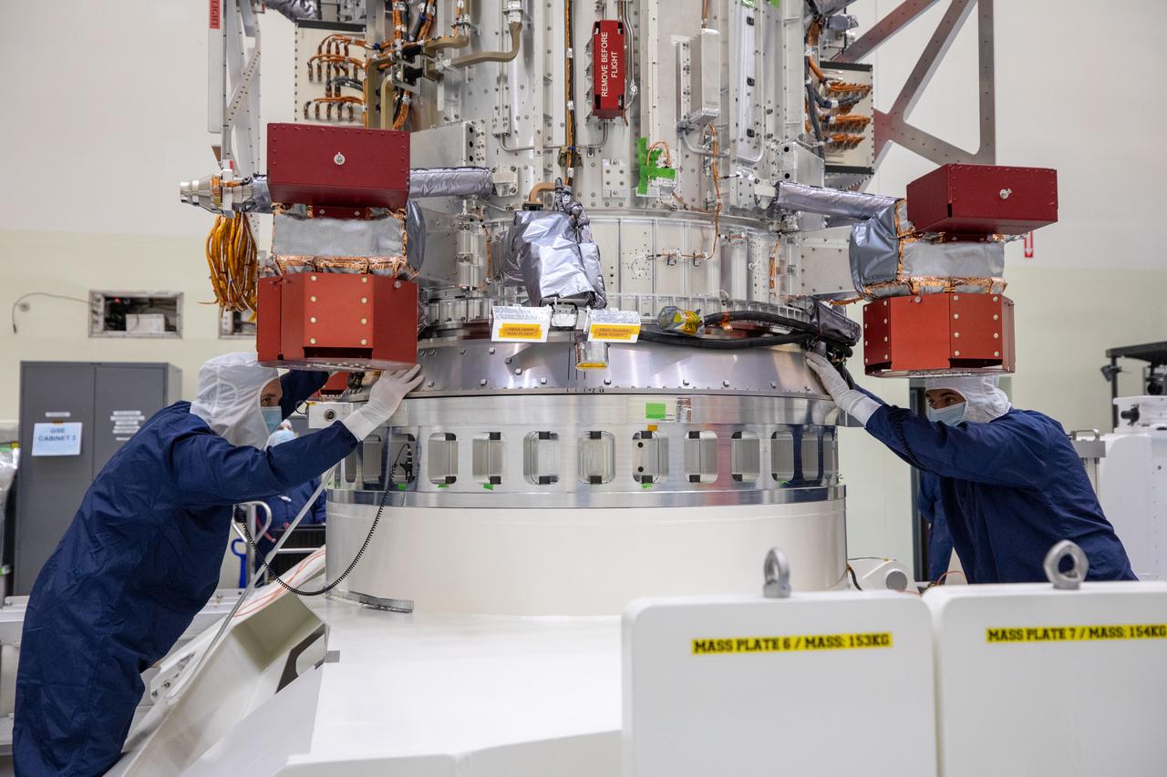 Technicians inside the Payload Hazardous Servicing Facility at NASA’s Kennedy Space Center in Florida monitor movement and guide the agency’s largest planetary mission spacecraft, Europa Clipper, as a crane hoists it on a stand as part of prelaunch processing on Tuesday, May 28, 2024. Slated to launch aboard a SpaceX Falcon Heavy rocket later this year from Launch Complex 39A at Kennedy, Europa Clipper will help determine if conditions exist below the surface Jupiter’s fourth largest moon, Europa that could support life.