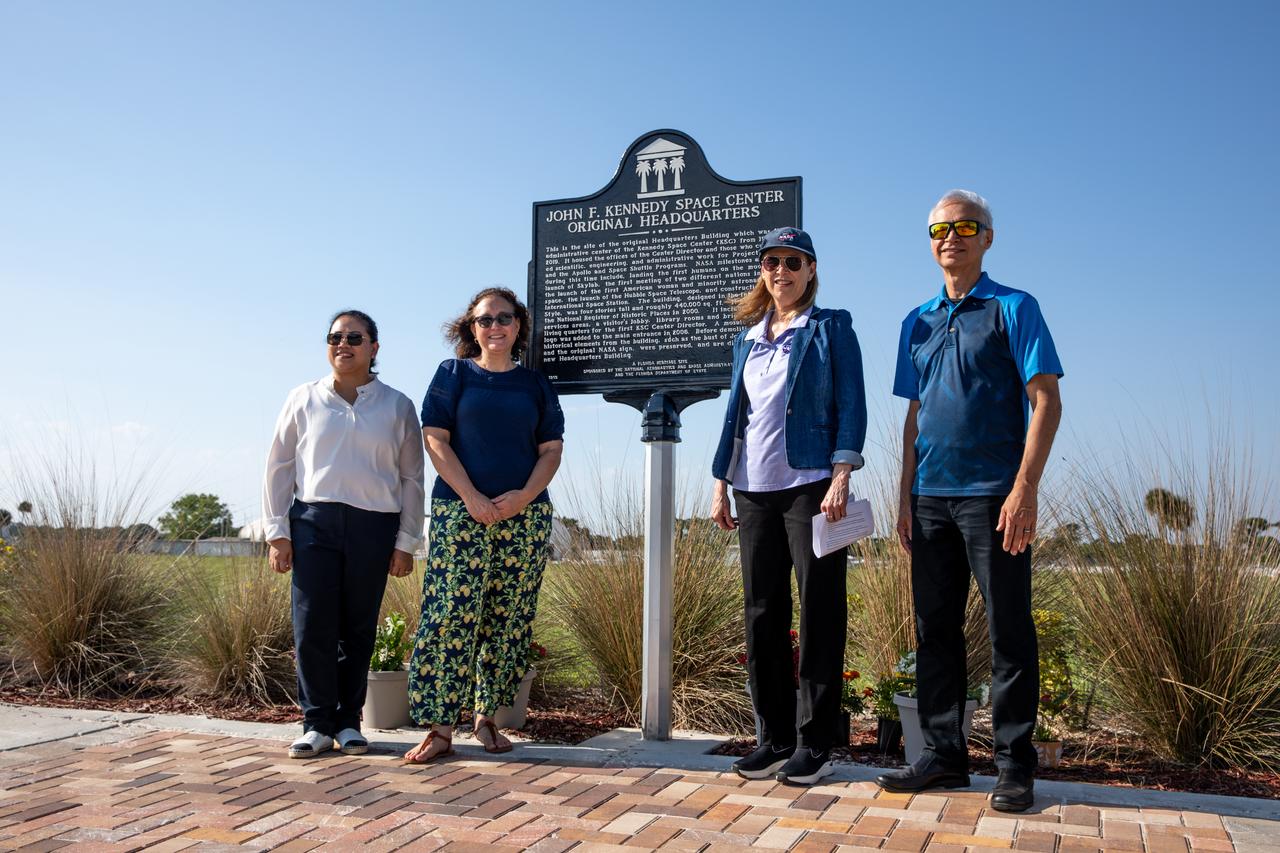 From the left, NASA Kennedy Space Center’s, Maui Dalton, project manager, engineering; Katherine Zeringue, cultural resources manager; Janet Petro, NASA Kennedy Space Center director; and Ismael Otero, project manager, engineering, present a large bronze historical marker plaque at the location of NASA Kennedy’s original headquarters building on Tuesday, May 28, 2024. Approved in April 2023 as part of the State of Florida’s Historical Markers program in celebration of National Historic Preservation Month, the marker commemorates the early days of space exploration and is displayed permanently just west of the seven-story, 200,000 square foot Central Campus Headquarters Building, which replaced the old building in 2019.   