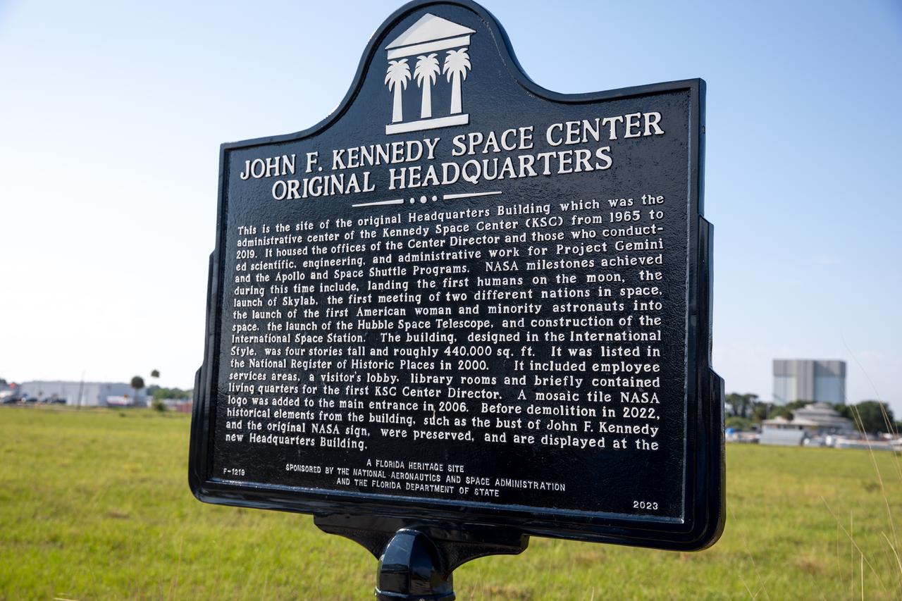 A large bronze historical marker plaque is unveiled Tuesday, May 28, 2024, at the location of NASA Kennedy Space Center’s original headquarters building. Approved in April 2023 as part of the State of Florida’s Historical Markers program in celebration of National Historic Preservation Month, the marker commemorates the early days of space exploration and is displayed permanently just west of the seven-story, 200,000 square foot Central Campus Headquarters Building, which replaced the old building in 2019.  