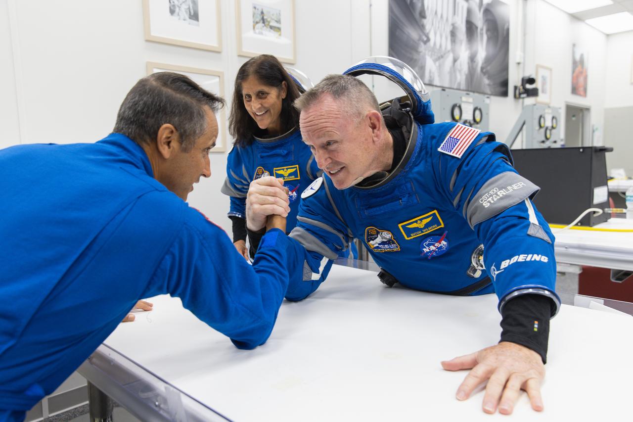 NASA’s Boeing Crew Flight Test astronaut Butch Wilmore participates in a round of arm wrestling with NASA astronauts Joseph Acaba after suit-up and final fit checks inside the Neil A. Armstrong Operations and Checkout Building at NASA’s Kennedy Space Center in Florida on Wednesday, June 5, 2024. As part of the agency’s Commercial Crew Program, Wilmore, joined by NASA astronaut Suni Williams, is preparing for launch to the International Space Station aboard Boeing’s Starliner spacecraft atop a United Launch Alliance Atlas V rocket from Space Launch Complex-41 at nearby Cape Canaveral Space Force Station at 10:52 a.m. EDT.