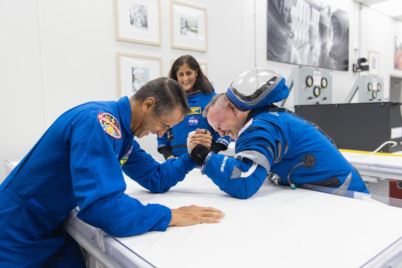 NASA’s Boeing Crew Flight Test astronaut Butch Wilmore participates in a round of arm wrestling with NASA astronauts Joseph Acaba after suit-up and final fit checks inside the Neil A. Armstrong Operations and Checkout Building at NASA’s Kennedy Space Center in Florida on Wednesday, June 5, 2024. As part of the agency’s Commercial Crew Program, Wilmore, joined by NASA astronaut Suni Williams, is preparing for launch to the International Space Station aboard Boeing’s Starliner spacecraft atop a United Launch Alliance Atlas V rocket from Space Launch Complex-41 at nearby Cape Canaveral Space Force Station at 10:52 a.m. EDT.