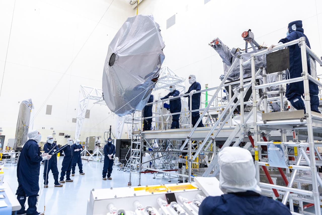 Technicians prepare to install the nearly 10 feet (3 meters) wide dish-shaped high-gain antenna to NASA’s Europa Clipper, a spacecraft to study Jupiter’s icy moon, at the agency’s Payload Hazardous Servicing Facility at Kennedy Space Center in Florida on Monday, June 17, 2024. The spacecraft will perform a series of flybys of the Jupiter moon Europa to gather data on its atmosphere, icy crust, and the ocean underneath, and the high-gain antenna will send the research data to scientists on Earth to determine if the moon can support habitable condition. The Europa Clipper spacecraft is scheduled to launch atop a SpaceX Falcon Heavy rocket from Kennedy’s Launch Complex 39A no earlier than October 2024. 