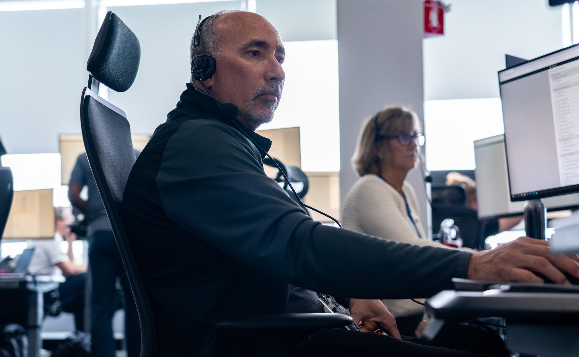 Image shows Albert Sierra, program manager for NASA’s Launch Services Program, wearing a black headset and blue shirt sitting near Jenny Lyons, wearing a white shirt. Lyons is replacing Sierra as program manager on April 1, 2026. Photo credit: SpaceX