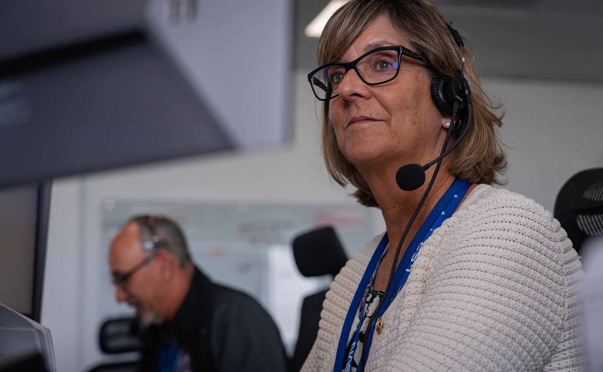 Image shows Jenny Lyon, acting program manager for NASA's Launch Services Program based at NASA Kennedy wearing a headset and a white knitted top. Photo credit: SpaceX