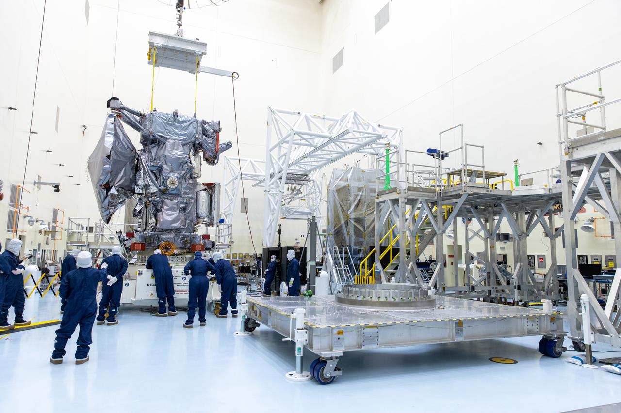 Technicians prepare to install the nearly 10 feet (3 meters) wide dish-shaped high-gain antenna to NASA’s Europa Clipper, a spacecraft to study Jupiter’s icy moon, at the agency’s Payload Hazardous Servicing Facility at Kennedy Space Center in Florida on Tuesday, June 18, 2024. The spacecraft will perform a series of flybys of the Jupiter moon Europa to gather data on its atmosphere, icy crust, and the ocean underneath, and the high-gain antenna will send the research data to scientists on Earth to determine if the moon can support habitable condition. The Europa Clipper spacecraft is scheduled to launch atop a SpaceX Falcon Heavy rocket from Kennedy’s Launch Complex 39A no earlier than October 2024.