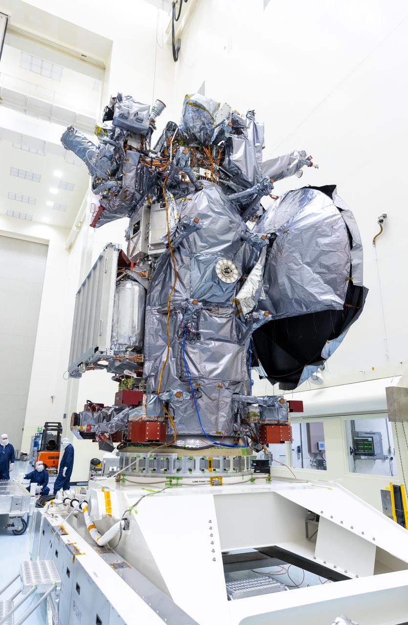 Technicians prepare to install the nearly 10 feet (3 meters) wide dish-shaped high-gain antenna to NASA’s Europa Clipper, a spacecraft to study Jupiter’s icy moon, at the agency’s Payload Hazardous Servicing Facility at Kennedy Space Center in Florida on Tuesday, June 18, 2024. The spacecraft will perform a series of flybys of the Jupiter moon Europa to gather data on its atmosphere, icy crust, and the ocean underneath, and the high-gain antenna will send the research data to scientists on Earth to determine if the moon can support habitable condition. The Europa Clipper spacecraft is scheduled to launch atop a SpaceX Falcon Heavy rocket from Kennedy’s Launch Complex 39A no earlier than October 2024.