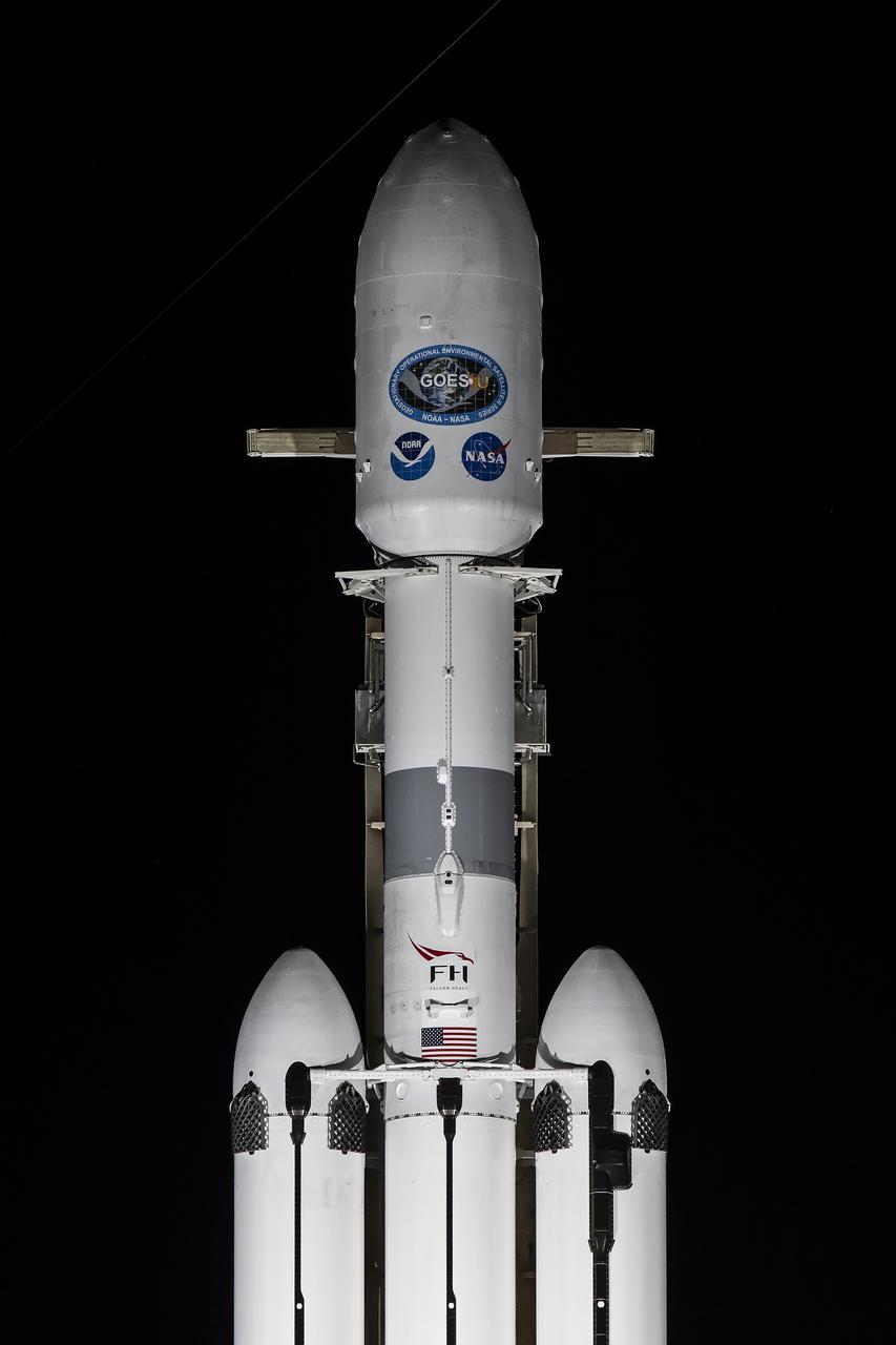 A SpaceX Falcon Heavy rocket carrying the National Oceanic and Atmospheric Administration (NOAA) GOES-U (Geostationary Operational Environmental Satellite U) stands vertical at Launch Complex 39A at NASA’s Kennedy Space Center in Florida on Monday, June 24, 2024. The GOES-U satellite is the final satellite in the GOES-R series, which serves a critical role in providing continuous coverage of the Western Hemisphere, including monitoring tropical systems in the eastern Pacific and Atlantic oceans. The two-hour launch window opens at 5:16 p.m. EDT. on Tuesday, June 25, 2024.