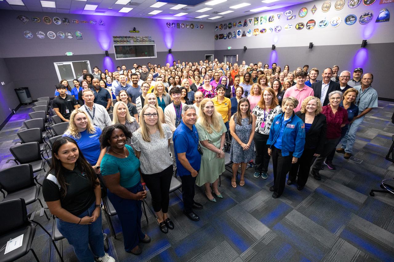 Retired NASA astronaut Eileen Collins poses with NASA employees and contractors after participating in a special presentation and question and answer session inside the Neil A. Armstrong Operations and Checkout Building’s Mission Briefing Room at the agency’s Kennedy Space Center in Florida on Wednesday, July 17, 2024. Collins visited NASA Kennedy in celebration of the 25th anniversary of becoming the first woman to command a space mission during STS-93, in which space shuttle Columbia lifted off from the spaceport’s Launch Complex 39B on July 23, 1999.