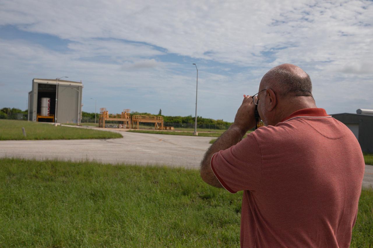 A member of the media takes a photo of the NASA worm on one of the solid rocket booster segments inside the Rotation, Processing and Surge Facility (RPSF) at Kennedy Space Center in Florida on Tuesday, July 23, 2024. The booster segments will help propel the SLS (Space Launch System) rocket on the Artemis II mission to send four astronauts around the Moon as part of the agency’s effort to establish a long-term science and exploration presence at the Moon, and eventually Mars.