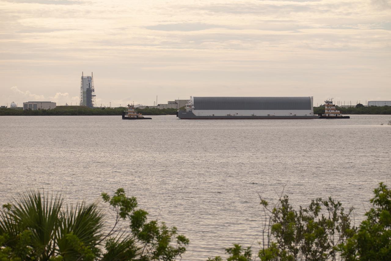NASA’s Pegasus barge, carrying the agency’s massive SLS (Space Launch System) core stage, arrives at NASA’s Kennedy Space Center Complex 39 turn basin wharf in Florida on Tuesday, July 23, 2024, after journeying from the agency’s Michoud Assembly Facility in New Orleans. The core stage is the next piece of Artemis hardware to arrive at the spaceport and will be offloaded and moved to NASA Kennedy’s Vehicle Assembly Building, where it will be prepared for integration ahead of the Artemis II launch.