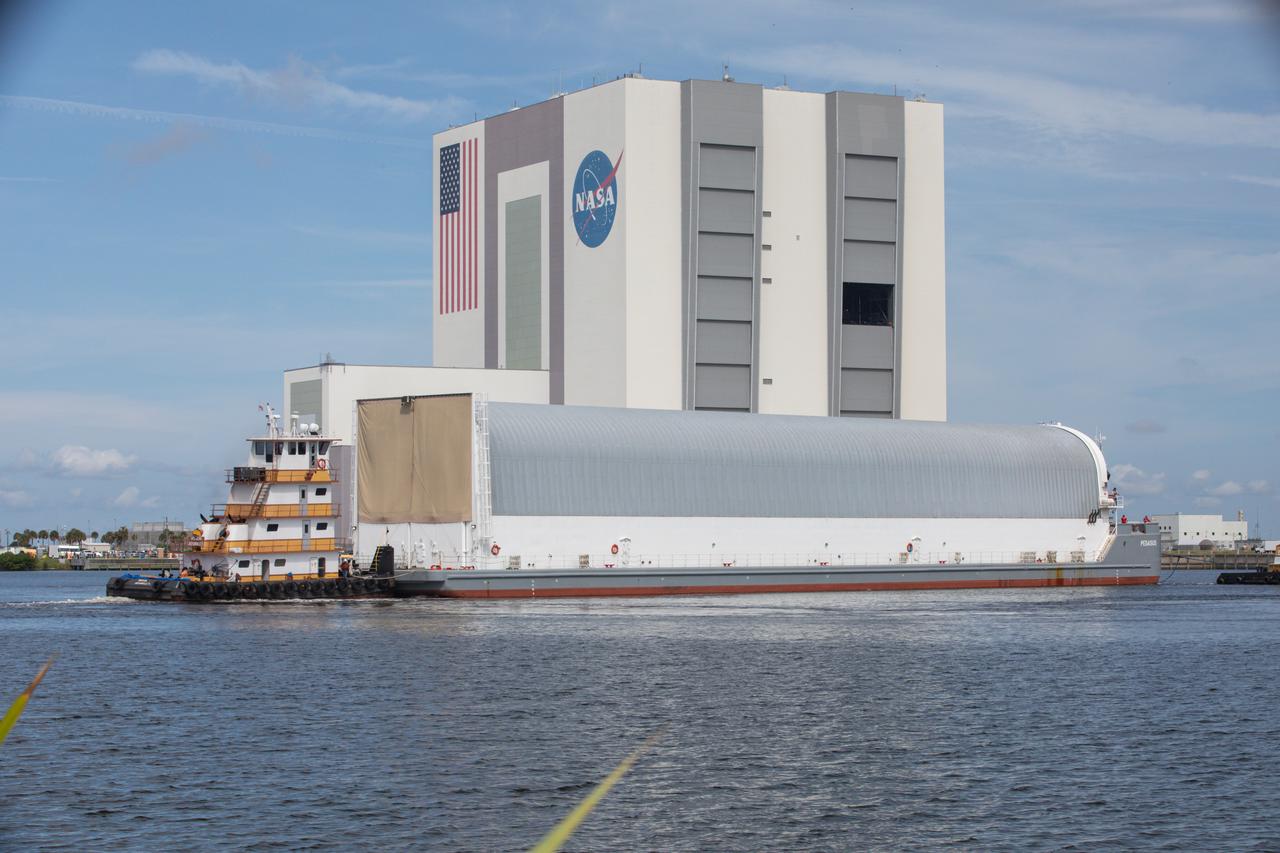 NASA’s Pegasus barge, carrying the agency’s massive SLS (Space Launch System) core stage, arrives at NASA’s Kennedy Space Center Complex 39 turn basin wharf in Florida on Tuesday, July 23, 2024, after journeying from the agency’s Michoud Assembly Facility in New Orleans. The core stage is the next piece of Artemis hardware to arrive at the spaceport and will be offloaded and moved to NASA Kennedy’s Vehicle Assembly Building, where it will be prepared for integration ahead of the Artemis II launch.