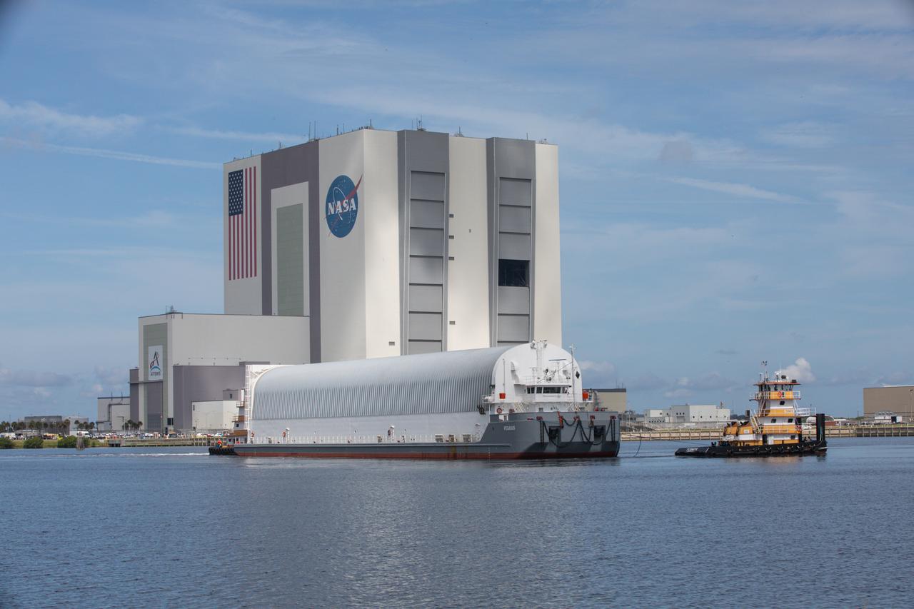 NASA’s Pegasus barge, carrying the agency’s massive SLS (Space Launch System) core stage, arrives at NASA’s Kennedy Space Center Complex 39 turn basin wharf in Florida on Tuesday, July 23, 2024, after journeying from the agency’s Michoud Assembly Facility in New Orleans. The core stage is the next piece of Artemis hardware to arrive at the spaceport and will be offloaded and moved to NASA Kennedy’s Vehicle Assembly Building, where it will be prepared for integration ahead of the Artemis II launch.