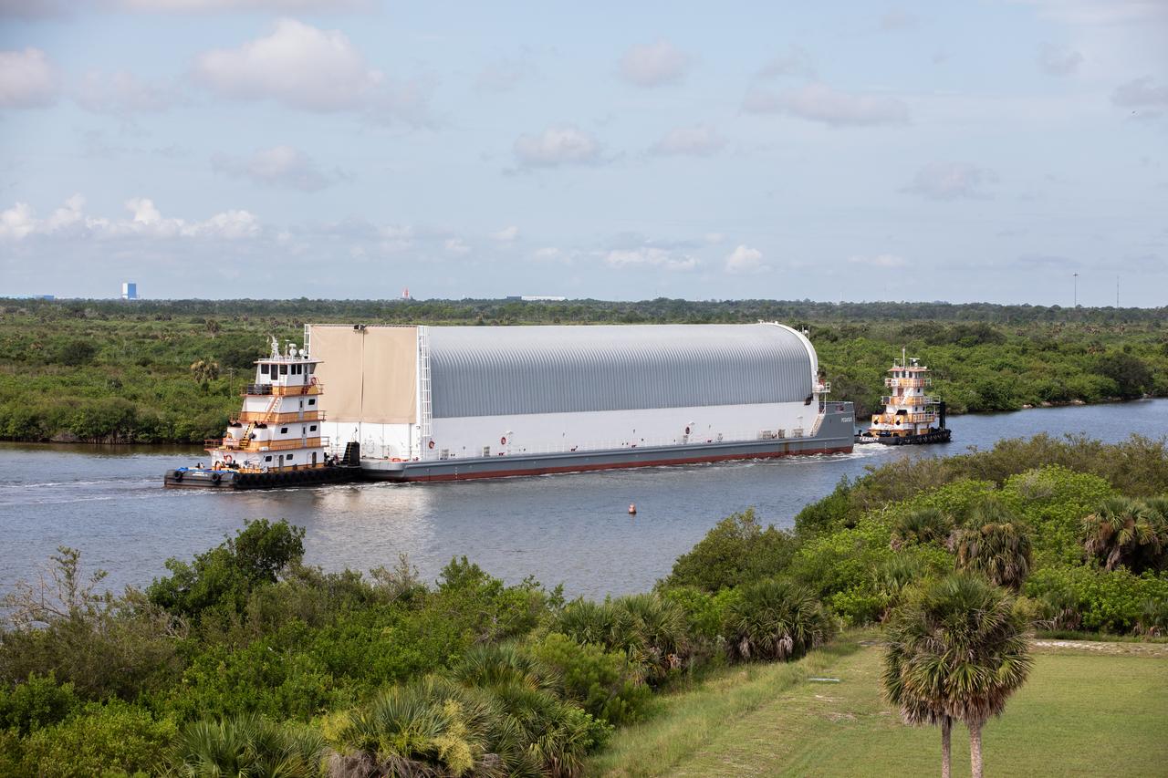 NASA’s Pegasus barge, carrying the agency’s massive SLS (Space Launch System) core stage, arrives at NASA’s Kennedy Space Center Complex 39 turn basin wharf in Florida on Tuesday, July 23, 2024, after journeying from the agency’s Michoud Assembly Facility in New Orleans. The core stage is the next piece of Artemis hardware to arrive at the spaceport and will be offloaded and moved to NASA Kennedy’s Vehicle Assembly Building, where it will be prepared for integration ahead of the Artemis II launch.