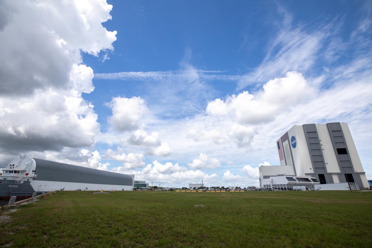 NASA’s Pegasus barge, carrying the agency’s massive SLS (Space Launch System) core stage, arrives at NASA’s Kennedy Space Center Complex 39 turn basin wharf in Florida on Tuesday, July 23, 2024, after journeying from the agency’s Michoud Assembly Facility in New Orleans. The core stage is the next piece of Artemis hardware to arrive at the spaceport and will be offloaded and moved to NASA Kennedy’s Vehicle Assembly Building, where it will be prepared for integration ahead of the Artemis II launch. 