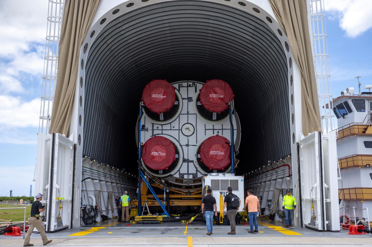 NASA’s Pegasus barge, carrying the agency’s massive SLS (Space Launch System) core stage, arrives at NASA’s Kennedy Space Center Complex 39 turn basin wharf in Florida on Tuesday, July 23, 2024, after journeying from the agency’s Michoud Assembly Facility in New Orleans. The core stage is the next piece of Artemis hardware to arrive at the spaceport and will be offloaded and moved to NASA Kennedy’s Vehicle Assembly Building, where it will be prepared for integration ahead of the Artemis II launch.